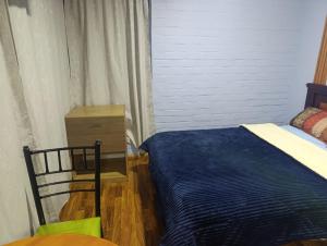a bedroom with a bed and a dresser at Hospedaje Carigan in Loja