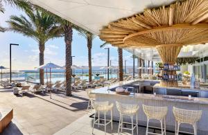 a resort with palm trees and a bar at Omni Fort Lauderdale Hotel in Fort Lauderdale