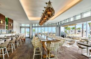 a restaurant with tables and chairs and a chandelier at Omni Fort Lauderdale Hotel in Fort Lauderdale
