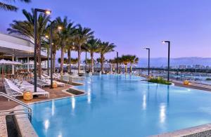 a large swimming pool with palm trees in a resort at Omni Fort Lauderdale Hotel in Fort Lauderdale