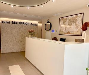 a hotel reference counter in a lobby with a clock at Hotel BESTPRICE Gracia in Barcelona