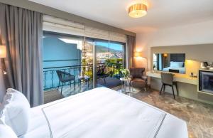 a hotel room with a bed and a balcony at Kalkan Regency in Kalkan +65 photos