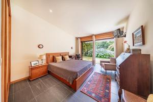 a bedroom with a bed and a living room at Casa do Rego - by Proguest in Valdosende