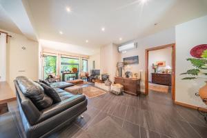 a living room with a leather couch and a table at Casa do Rego - by Proguest in Valdosende
