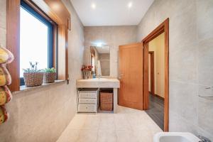 a bathroom with a sink and a mirror at Casa do Rego - by Proguest in Valdosende +43 photos