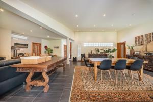 a living room with a wooden table and chairs at Casa do Rego - by Proguest in Valdosende