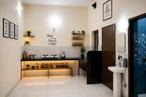 a bathroom with a counter with bottles on it at Homies Homestay Boys Hostel in Kurukshetra