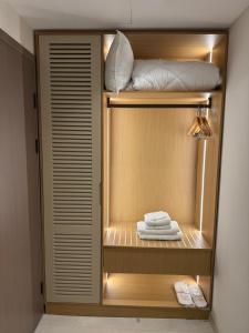 a closet with some white towels on a shelf at DriArt Center in Tirana