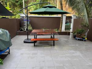 a picnic table and an umbrella on a patio at Resilience 9 in Kota Kinabalu