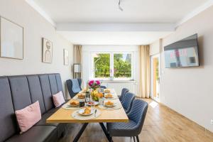 a dining room with a table and blue chairs at Ferienhaus Primavera in Mörsdorf