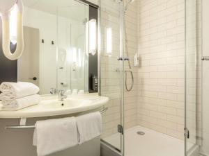 a white bathroom with a sink and a shower at ibis Blois Centre Château in Blois +66 photos