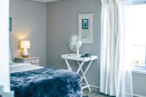 a bedroom with a bed and a table with a mirror at Lalandi 14 - Beachfront Self-Catering- Langstrand Walvis Bay in Langstrand