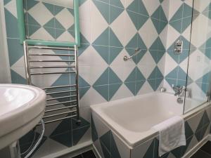 a bathroom with a sink and a tub at Pegs in Porthleven +17 photos