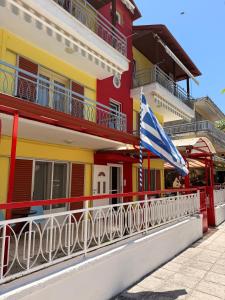 an american flag on a balcony of a building at Amphitrite's Paradise Apartments in Olympic Beach