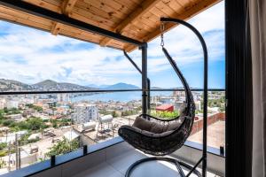a swing hanging from the ceiling of a room with a view at Crown Villa in Sarandë