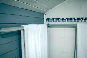 a bathroom with a towel hanging on a shower door at Lalandi 14 - Beachfront Self-Catering- Langstrand Walvis Bay in Langstrand +43 photos