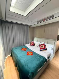 a bedroom with a large bed with red pillows on it at ZEVS-Holiday Complex in Deu