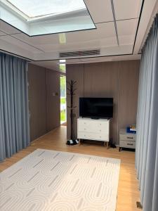 a living room with a flat screen tv and a tv stand at ZEVS-Holiday Complex in Deu +19 photos
