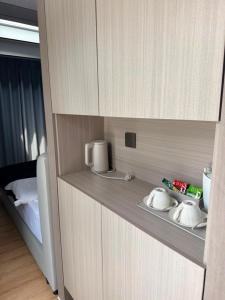 a room with a bed and a counter with aperature at ZEVS-Holiday Complex in Deu