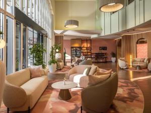 a lobby with couches and chairs and a table at Mercure Salzburg City in Salzburg