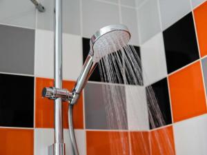 a shower head with water being being washed at ibis Styles Caen Centre Historique in Caen +43 photos