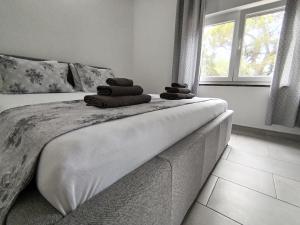 a bedroom with a bed with towels on it at Holiday home I.D.A. in Banjole