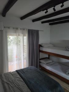 a bedroom with two bunk beds and a window at Complejo Heliópolis in Piriápolis