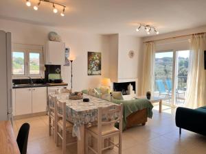 a kitchen and a living room with a table at Lakithra Apartments in Kefallonia