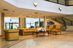 a lobby with couches and chairs and a staircase at Ninety Hotel in São Paulo +50 photos