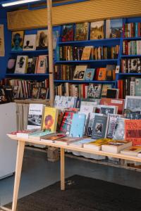 a table with books on it in a library at The Hoxton, Shepherds Bush in London