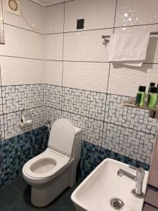 a bathroom with a toilet and a sink at Lakeside Meadows- Diamond Homestay in Kollam +45 photos