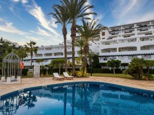 a swimming pool in front of a large building at Heavenly Homes Mojacar 75 in Mojácar