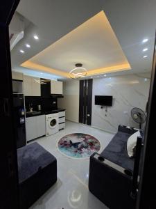 a living room with a couch and a kitchen at Hurghada HuB in Hurghada