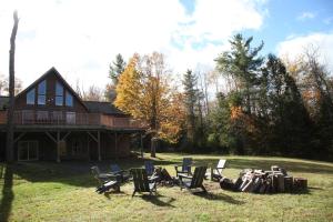 a group of chairs in front of a house at Kaaterskill Mountain House - 287 Acres with Fire Pit in Elka Park