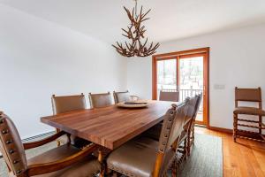 a dining room with a wooden table and chairs at Kaaterskill Mountain House - 287 Acres with Fire Pit in Elka Park