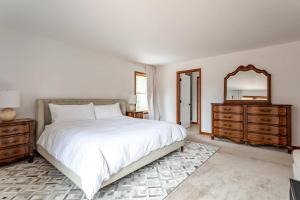 a bedroom with a large white bed and a mirror at Kaaterskill Mountain House - 287 Acres with Fire Pit in Elka Park +37 photos