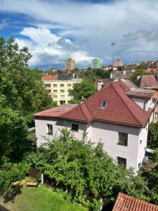 a building with a red roof in a city at Máneska in Cheb