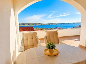 a table and chairs with a view of the ocean at Villa Grubešić - Sea View Apartments in Kustići
