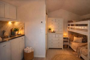 a small kitchen with a sink and a bunk bed at Naturstugan in Nacka in Ormingelandet