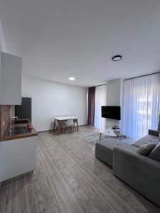 a living room with a couch and a table at Angelo Apartments Ilyonis Residence in Shëngjin