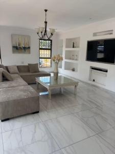 a living room with a couch and a coffee table at Monti's Villa Suites in Southgate
