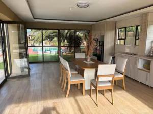 a dining room with a table and chairs at Monti's Villa Suites in Southgate