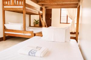 a bedroom with two bunk beds with white pillows at Jurisu Resort in San Vicente
