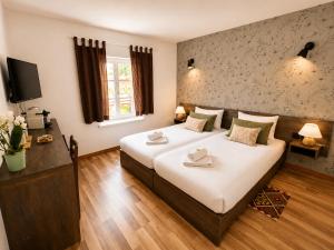 a bedroom with a large bed with two towels on it at Au Bon Gîte in Senones