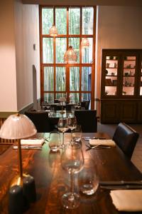 a long wooden table with wine glasses on it at Au Bon Gîte in Senones