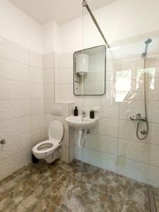 a bathroom with a toilet and a sink and a mirror at Apartmani Gradska in Prijepolje +16 photos