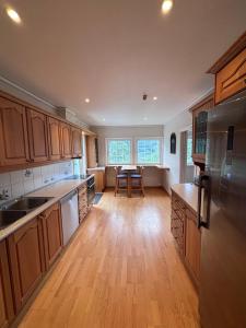 a kitchen with wooden cabinets and a table in it at Stryn Panorama in Stryn +10 photos