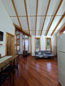 a living room with a bed in the middle of it at Refugio entre Coihues in Melipeuco