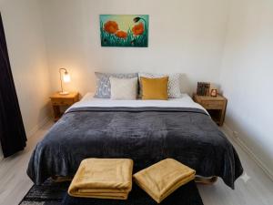 a bedroom with a large bed with two night stands at My Sweet Home in Fauske
