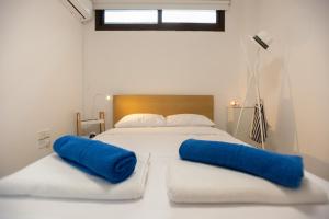 a bedroom with a bed with blue pillows on it at Villa Kokona Private Pool Sea View in Sophtadhes